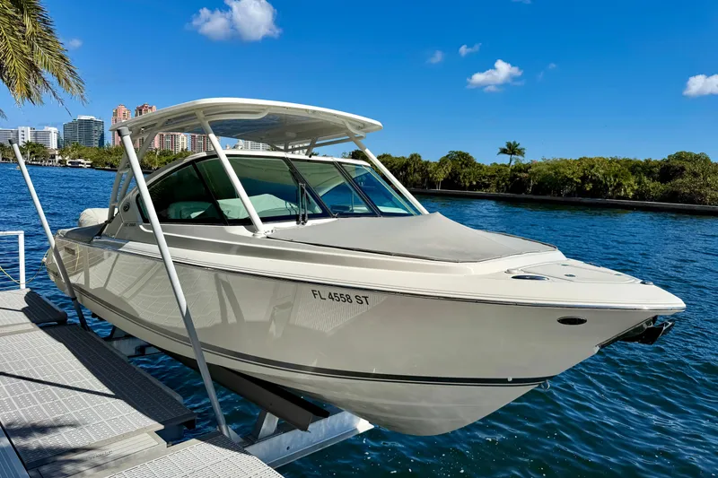 Slide: The Image of 2020 Pursuit DC 266 Dual Console boat docked on a sunny waterfront. - 6