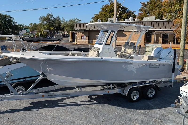 The Image of 2026 Key West 260 Center Console boat on trailer, parked outdoors. - 0