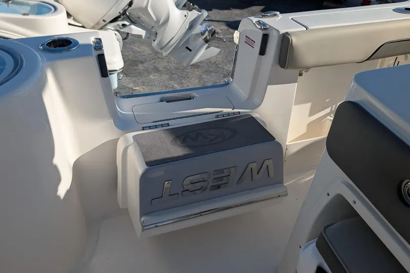 Slide: The Image of 2026 Key West 260 Center Console boat interior with seating and motor detail. - 10