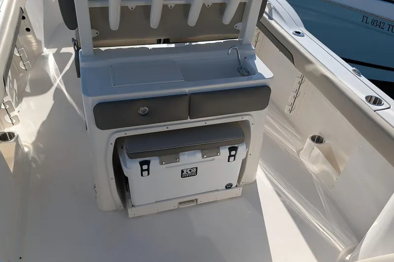 Slide: The Image of 2026 Key West 260 Center Console boat interior with sink and cooler. - 14
