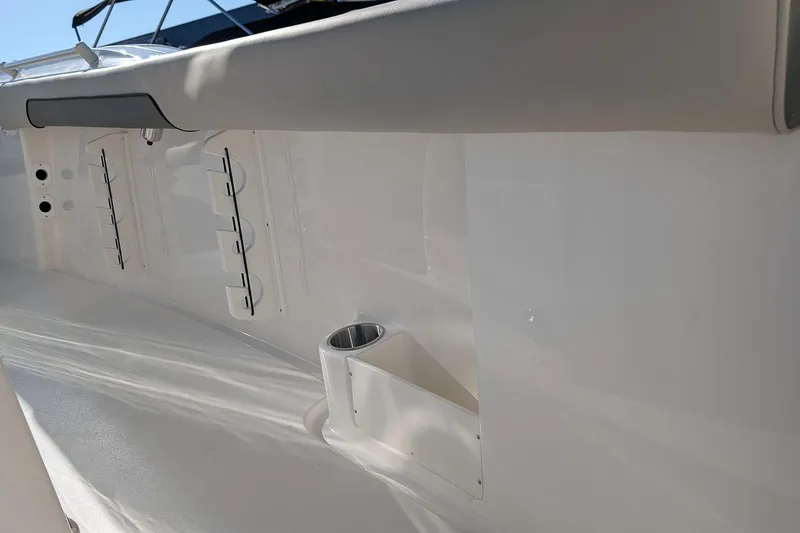 Slide: The Image of 2026 Key West 260 Center Console boat interior detail with rod holders and cup holder. - 15
