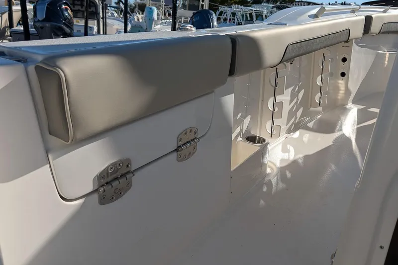 Slide: The Image of 2026 Key West 260 Center Console boat interior with cushioned seating and storage compartments. - 16