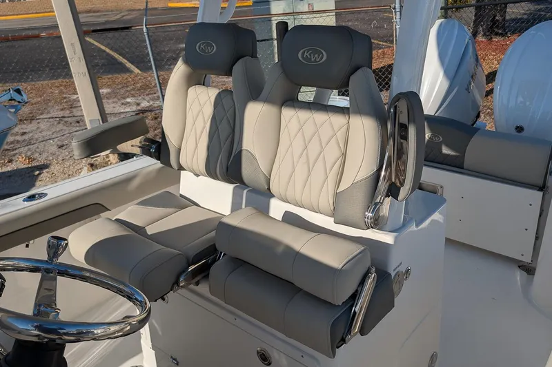 Slide: The Image of 2026 Key West 260 Center Console boat interior with luxurious seating and steering wheel. - 17