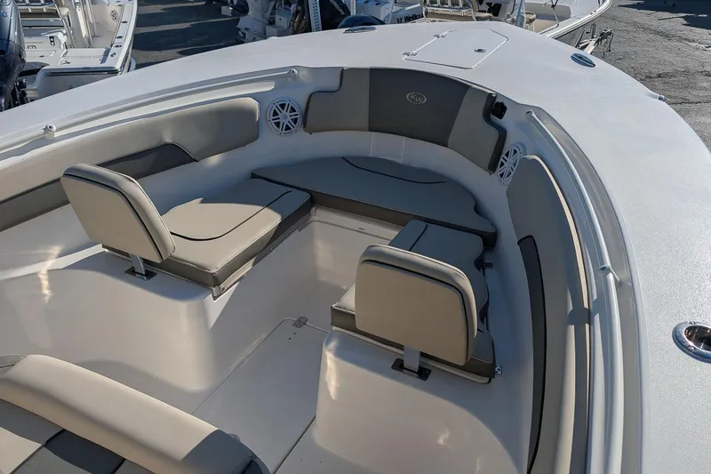 Slide: The Image of 2026 Key West 260 Center Console boat interior with cushioned seating and speakers. - 20