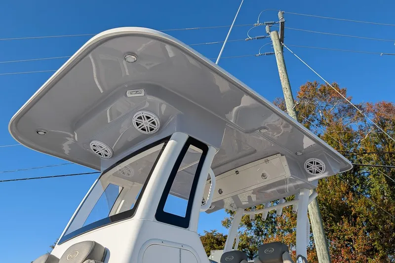 Slide: The Image of 2026 Key West 260 Center Console boat with sleek T-top and integrated speakers. - 23