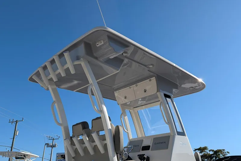 Slide: The Image of 2026 Key West 260 Center Console boat with T-top under clear blue sky. - 24