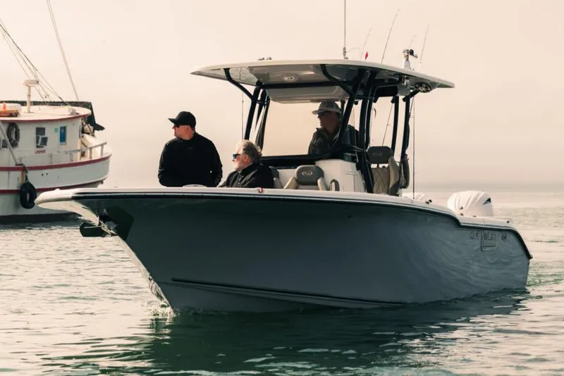 Slide: The Image of Manufacturer Provided Image: 2025 Key West 260 Center Console boat with passengers on calm water. - 25