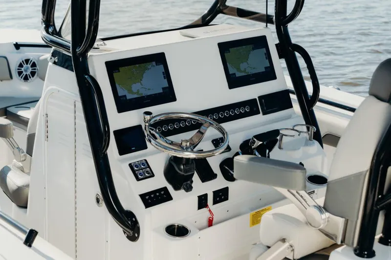 Slide: The Image of Manufacturer Provided Image: 2025 Key West 260 Center Console boat dashboard with dual screens and steering wheel. - 29