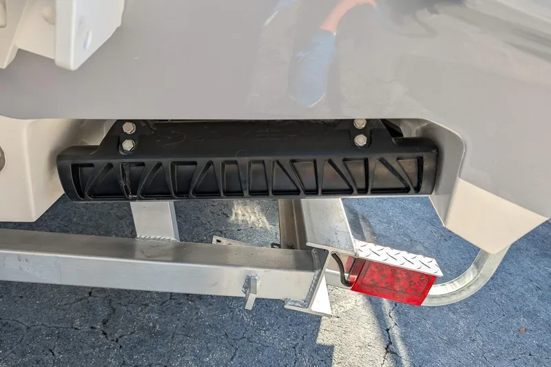 Slide: The Image of 2026 Key West 260 Center Console boat trailer detail with black bumper and red reflector. - 4