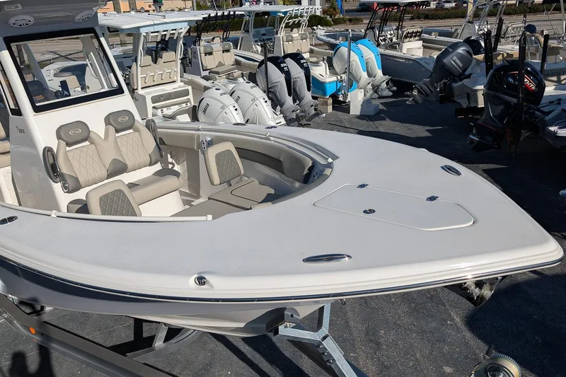 Slide: The Image of 2026 Key West 260 Center Console boat displayed in a showroom with other boats. - 8