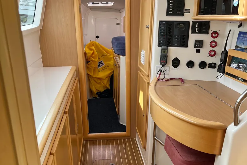 Slide: The Image of Interior of 2008 Seawind 1160 catamaran with control panel and wooden cabinetry. - 13