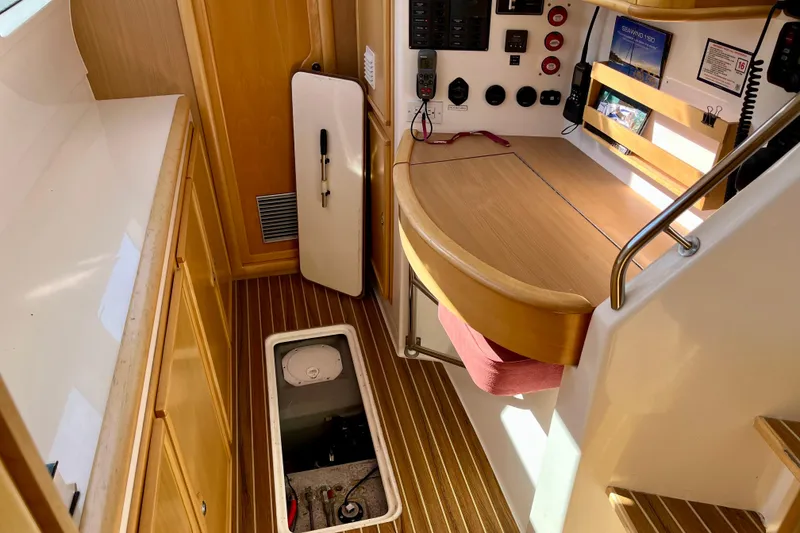 Slide: The Image of Interior of 2008 Seawind 1160 catamaran with navigation station and storage compartments. - 14