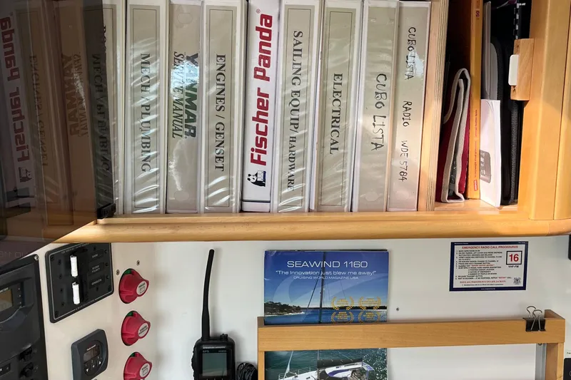 Slide: The Image of Manuals and equipment for Seawind 1160 yacht, 2008 model, neatly organized on a shelf. - 15
