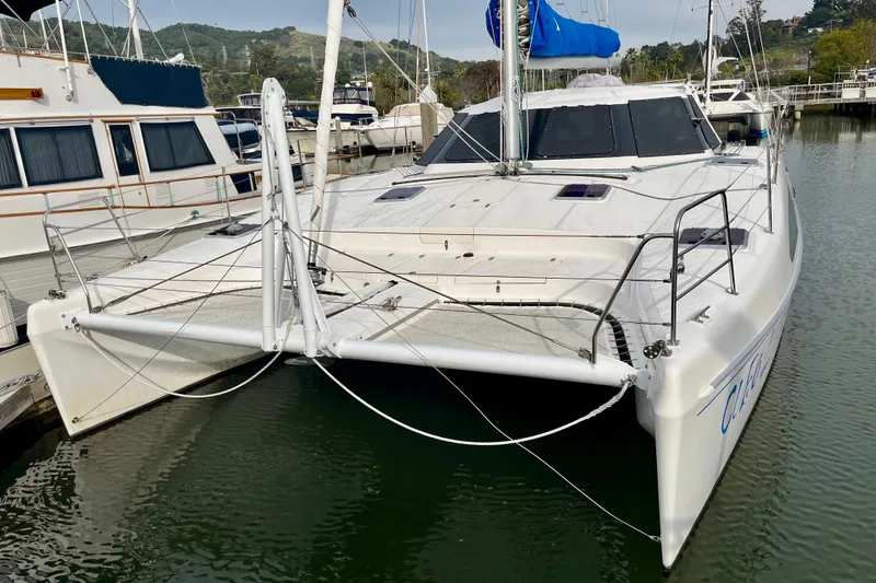 Slide: The Image of 2008 Seawind 1160 catamaran docked in a marina, featuring sleek design and spacious deck. - 2