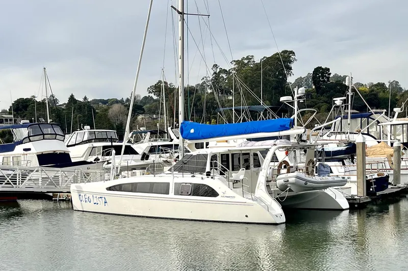 Slide: The Image of 2008 Seawind 1160 catamaran docked at a marina with other boats. - 24