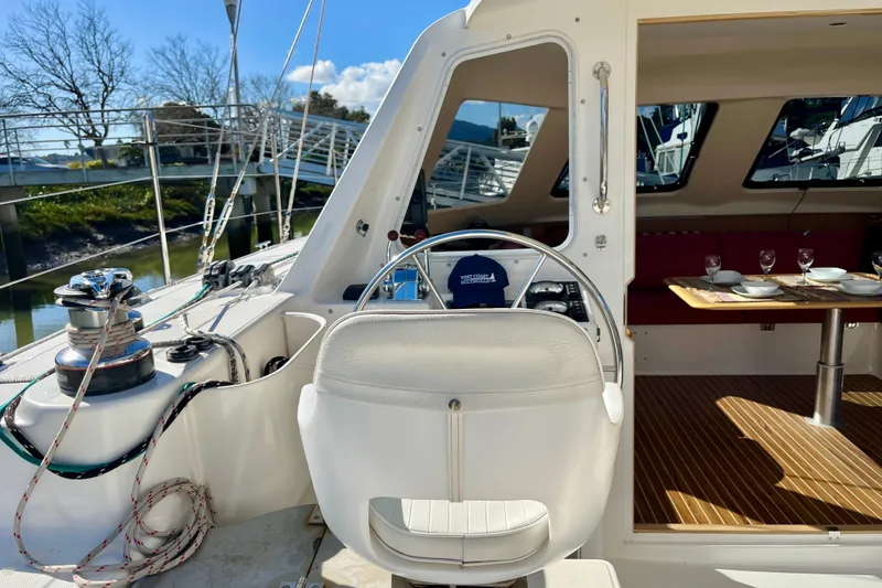 Slide: The Image of 2008 Seawind 1160 yacht interior with helm, dining area, and nautical equipment. - 5