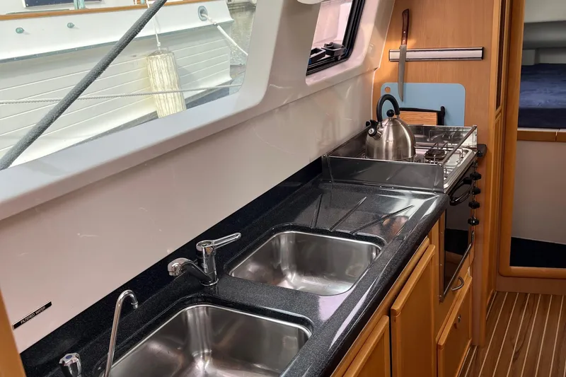Slide: The Image of Galley kitchen in 2008 Seawind 1160 catamaran with dual sinks and stove. - 8