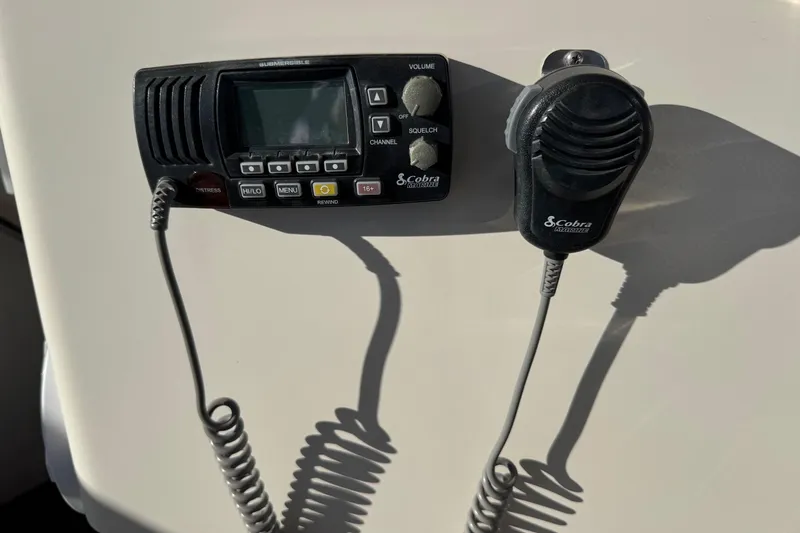 Slide: The Image of Cobra marine radio on 2002 Sport-Craft 3150 Sportfish boat dashboard. - 10