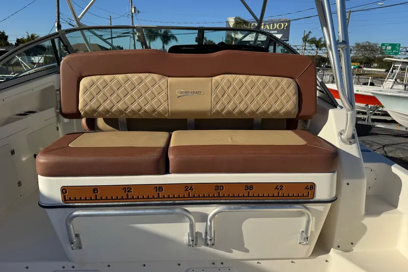 Slide: The Image of Sport-Craft 3150 Sportfish 2002 boat seat with measuring ruler, brown and beige upholstery. - 17