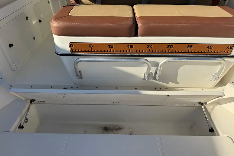 Slide: The Image of 2002 Sport-Craft 3150 Sportfish boat seating with built-in measuring ruler and storage compartment. - 18