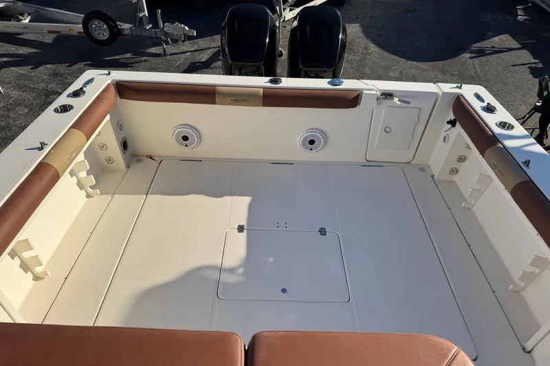 Slide: The Image of 2002 Sport-Craft 3150 Sportfish boat deck with cushioned seating and storage compartments. - 19