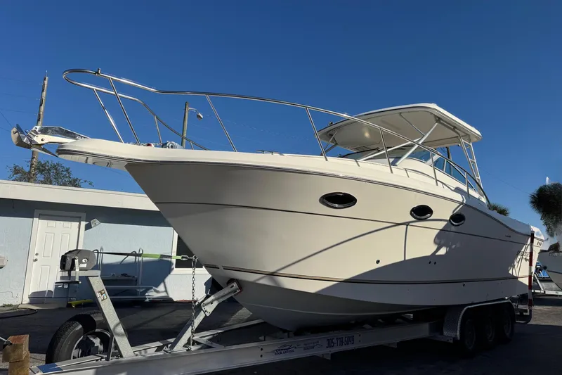 Slide: The Image of 2002 Sport-Craft 3150 Sportfish boat on trailer under clear blue sky. - 2