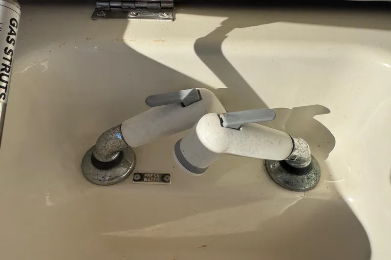 Slide: The Image of Freshwater taps on a 2002 Sport-Craft 3150 Sportfish boat sink. - 21