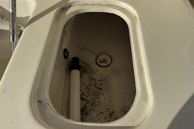 Slide: The Image of 2002 Sport-Craft 3150 Sportfish boat compartment with drain and pipe. - 22