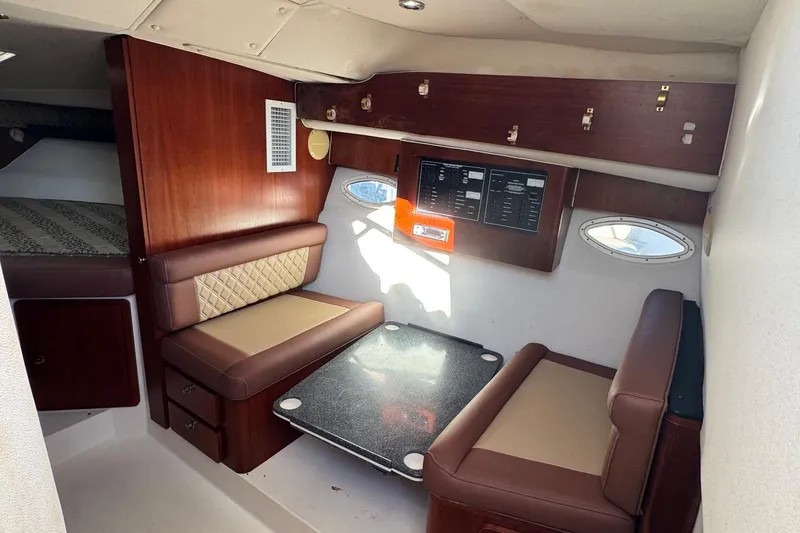 Slide: The Image of 2002 Sport-Craft 3150 Sportfish cabin interior with seating and control panel. - 25