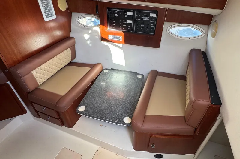 Slide: The Image of 2002 Sport-Craft 3150 Sportfish cabin interior with seating and control panel. - 27