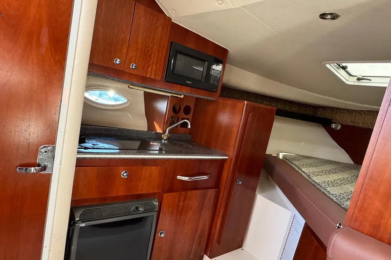 Slide: The Image of 2002 Sport-Craft 3150 Sportfish cabin interior with kitchenette and sleeping area. - 28