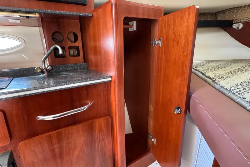 Slide: The Image of 2002 Sport-Craft 3150 Sportfish interior with wooden cabinetry and compact sink. - 32