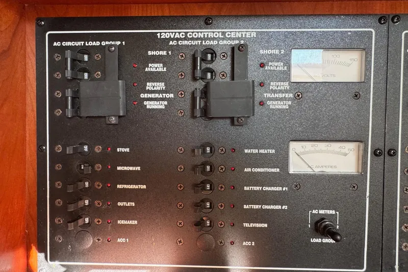 Slide: The Image of 2002 Sport-Craft 3150 Sportfish 120VAC control center with circuit breakers and meters. - 35