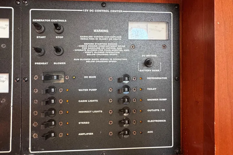 Slide: The Image of Control panel of a 2002 Sport-Craft 3150 Sportfish boat with various switches and gauges. - 36