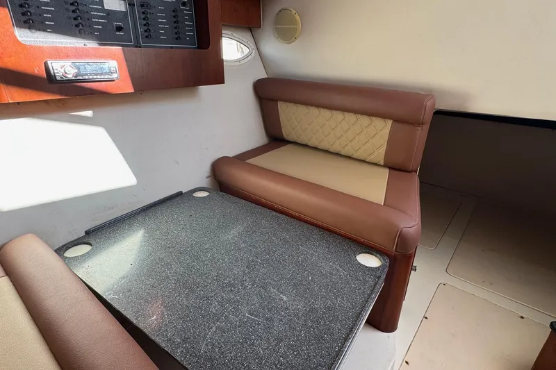 Slide: The Image of 2002 Sport-Craft 3150 Sportfish cabin interior with seating and table. - 38