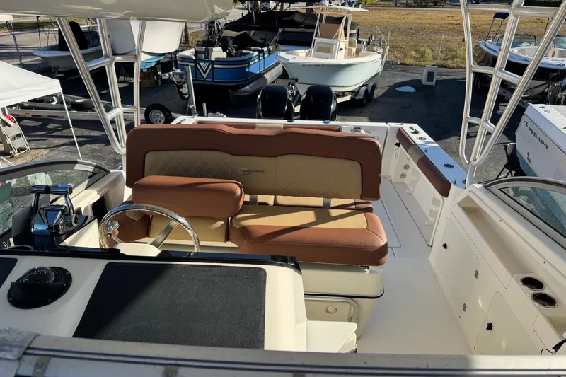 Slide: The Image of 2002 Sport-Craft 3150 Sportfish boat interior with tan seating and steering wheel. - 4