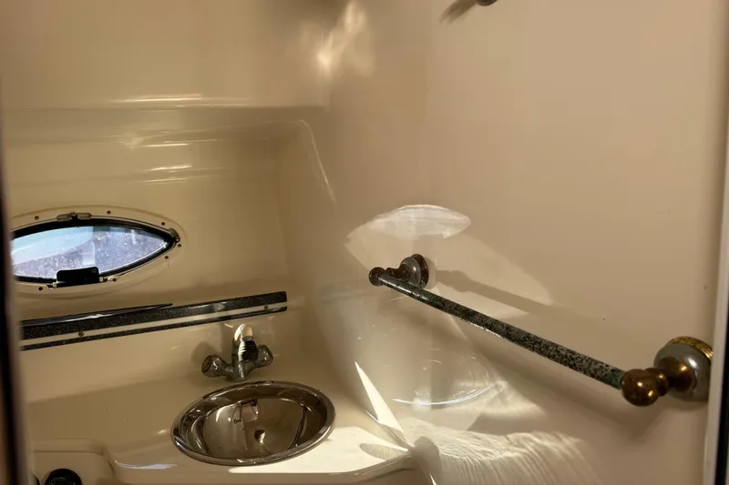 Slide: The Image of 2002 Sport-Craft 3150 Sportfish boat interior with sink and porthole window. - 40