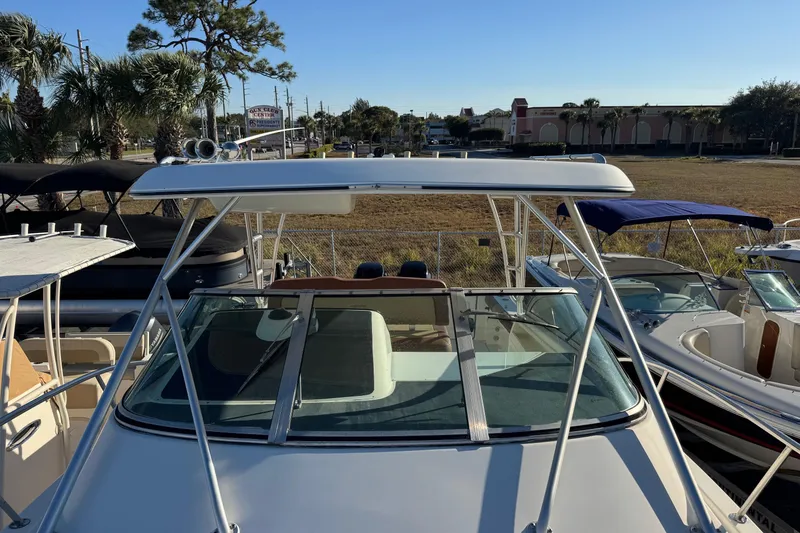 Slide: The Image of 2002 Sport-Craft 3150 Sportfish boat with T-top and windshield, docked among other boats. - 44