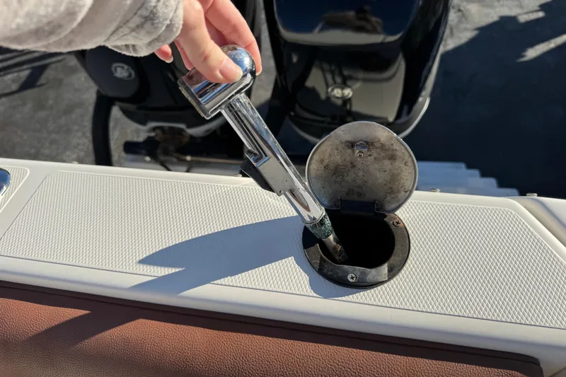Slide: The Image of Hand inserting fuel nozzle into 2002 Sport-Craft 3150 Sportfish boat. - 47