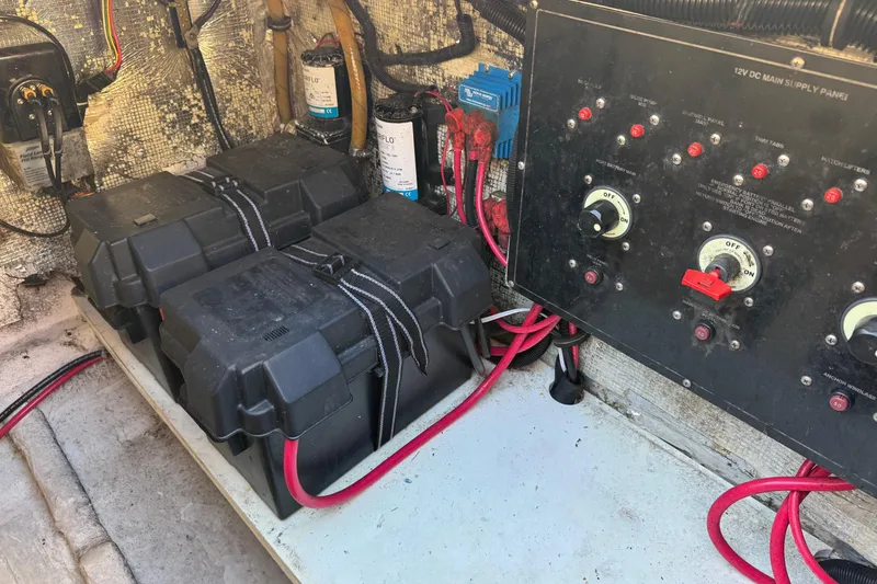 Slide: The Image of Electrical panel and battery setup in a 2002 Sport-Craft 3150 Sportfish boat. - 48
