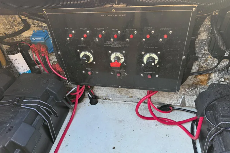 Slide: The Image of Control panel of a 2002 Sport-Craft 3150 Sportfish boat with wiring and switches. - 49