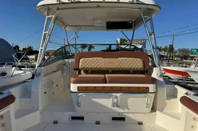 Slide: The Image of 2002 Sport-Craft 3150 Sportfish boat interior with cushioned seating and measuring ruler. - 5