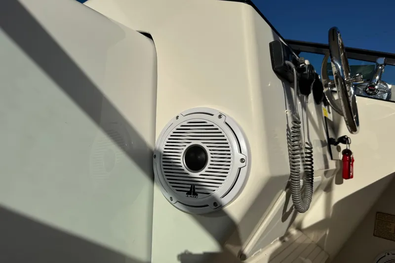 Slide: The Image of 2002 Sport-Craft 3150 Sportfish boat dashboard with speaker and steering wheel. - 54