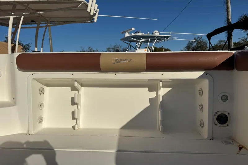 Slide: The Image of 2002 Sport-Craft 3150 Sportfish boat interior with storage compartment and padded seating. - 56