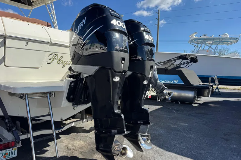Slide: The Image of 2002 Sport-Craft 3150 Sportfish boat with dual Mercury 400 engines, docked outdoors. - 59