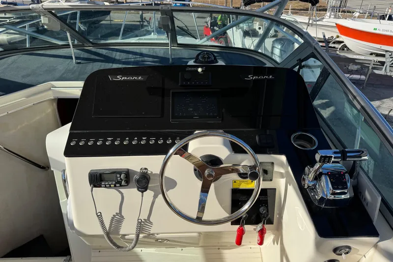 Slide: The Image of 2002 Sport-Craft 3150 Sportfish boat helm with steering wheel and control panel. - 6