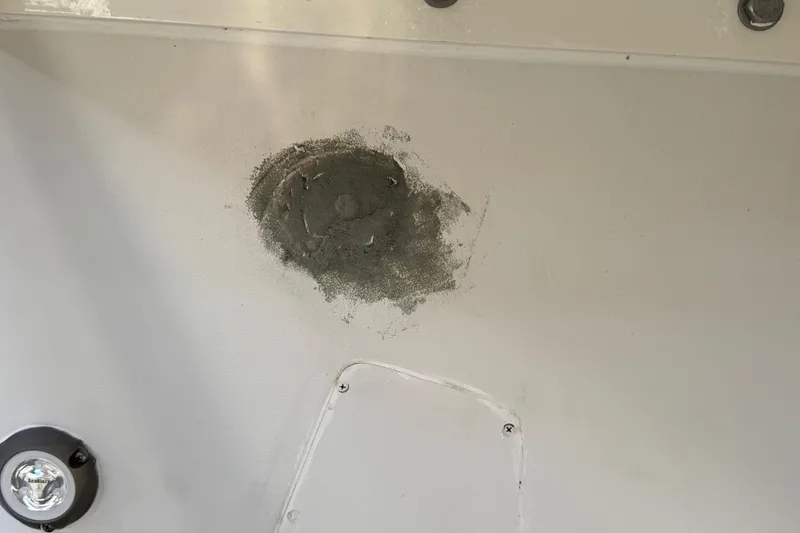 Slide: The Image of 2002 Sport-Craft 3150 Sportfish boat hull with visible repair patch. - 67