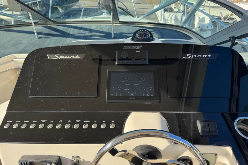 Slide: The Image of 2002 Sport-Craft 3150 Sportfish dashboard with steering wheel and control panel. - 7