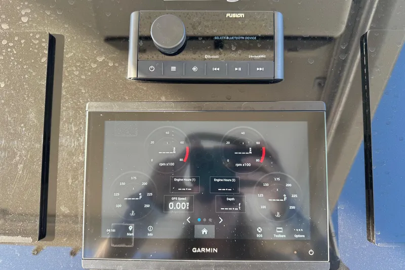 Slide: The Image of Garmin marine display and Fusion Bluetooth device on 2002 Sport-Craft 3150 Sportfish boat. - 8