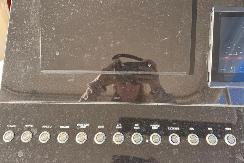 Slide: The Image of Control panel of a 2002 Sport-Craft 3150 Sportfish boat with various switches and displays. - 9